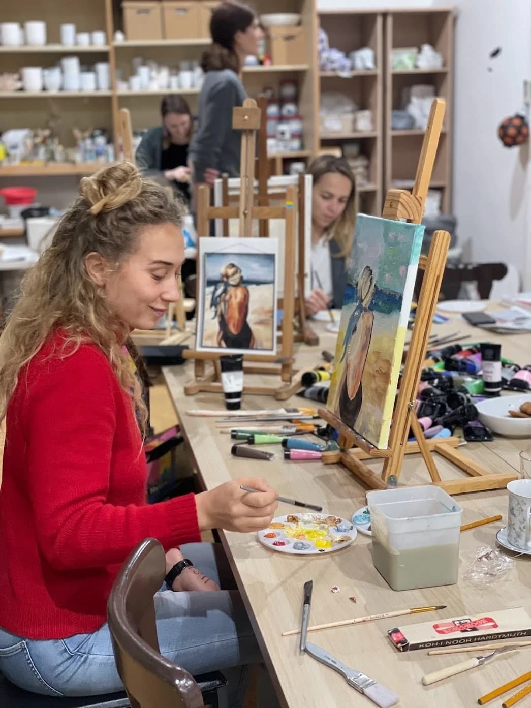 Woman painting on canvas