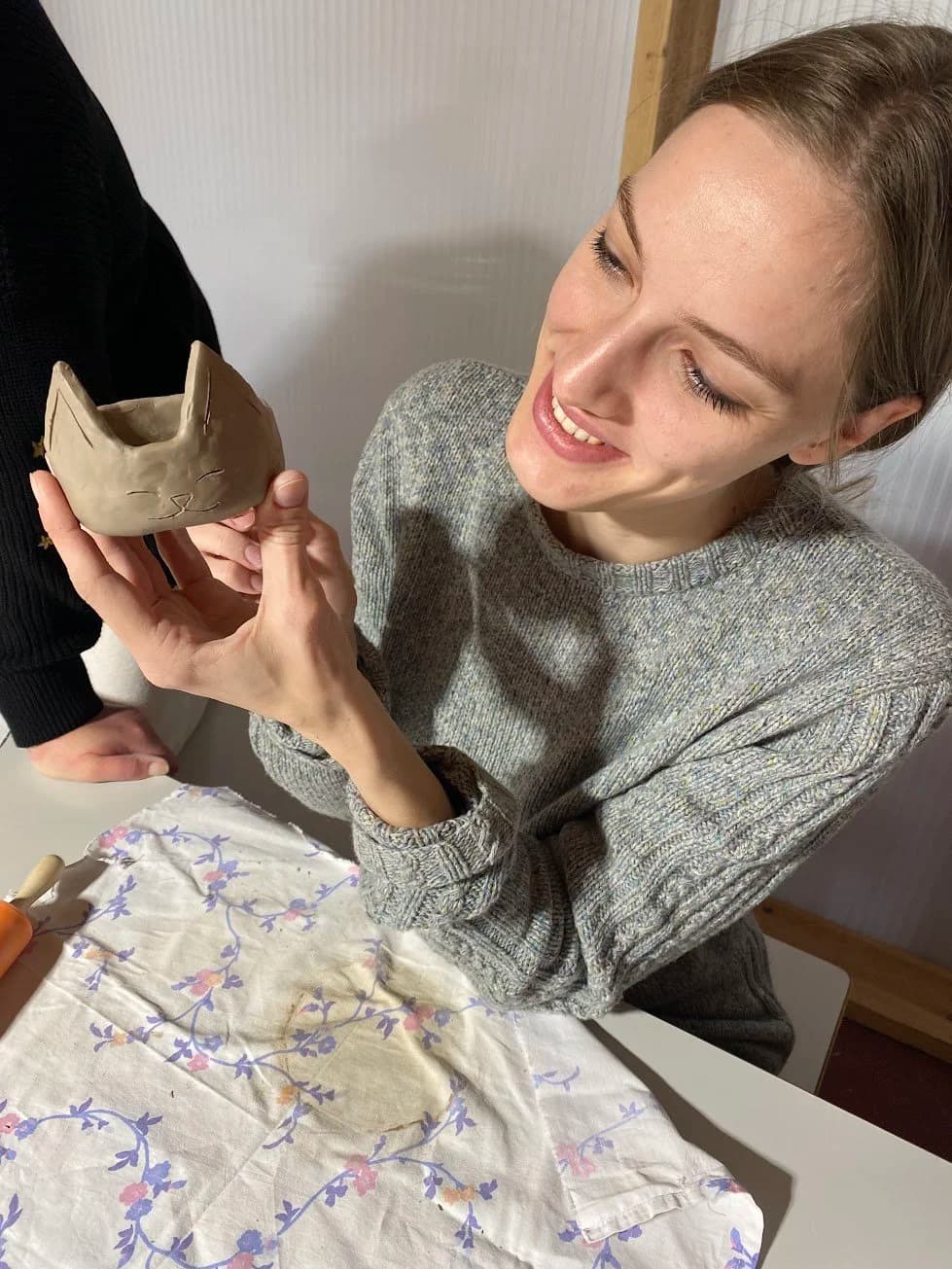 Woman holding ceramic cat cup